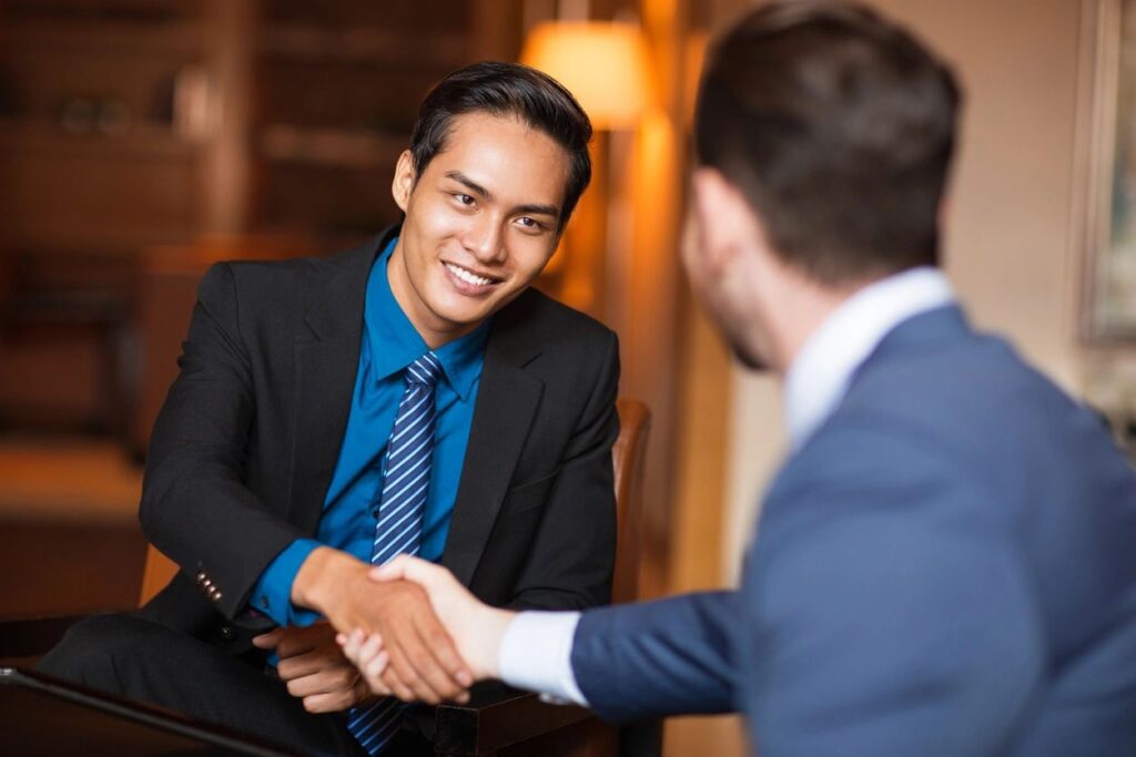 Two men shaking hands in a professional setting, symbolizing a successful hire through Bay Recruiters' staffing solutions.